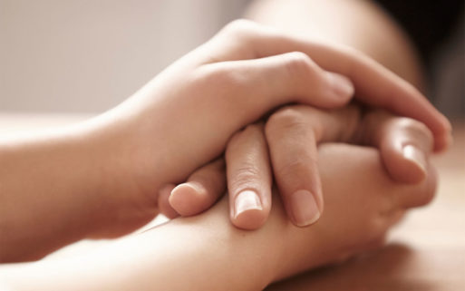Holding the hands of a grieving friend