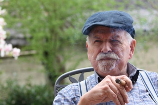 Alzheimer village increases quality of life of dementia patients like this elderly man sitting outdoors