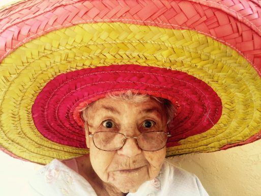 an image of an elderly woman in a colorful hat