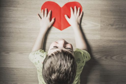 Image of boy with cutout heart representing organ donation and the 2018 Transplant Games