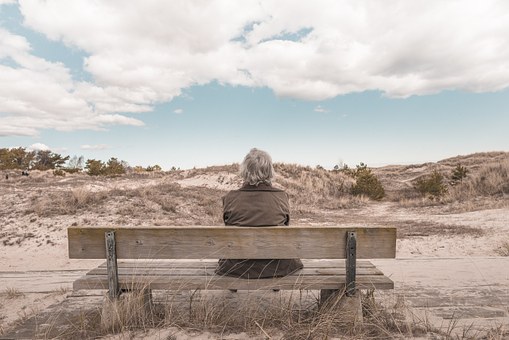 A lost Alzheimer's patient sits alone 