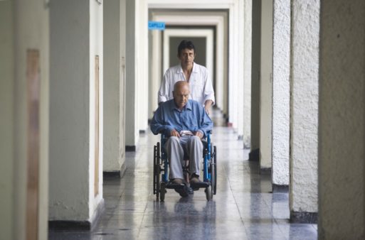 Elderly man in a wheelchair being taken for rehabilitation services
