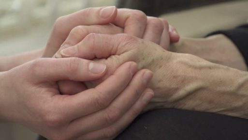 Holding the hands of someone who is dying