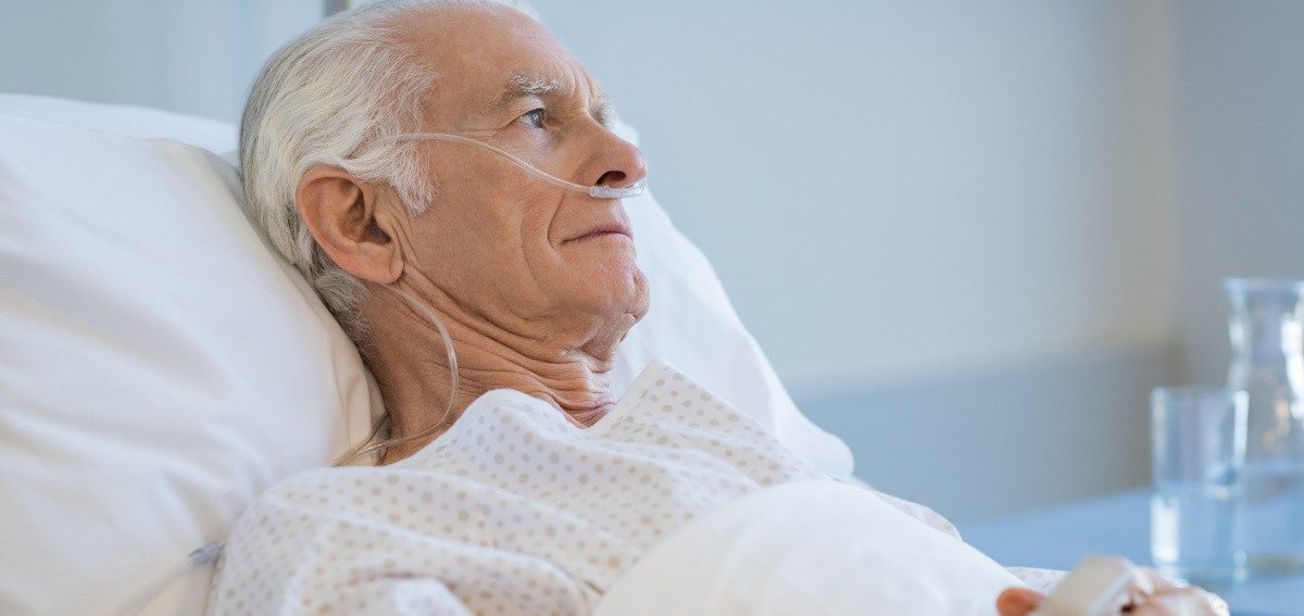 A man in a nursing home receiving comfort care rather than rehabilitation services