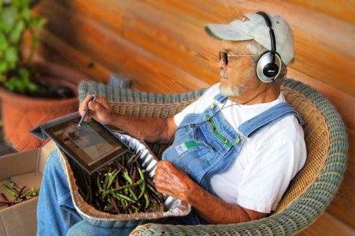 Elderly man with headphones listening to music 