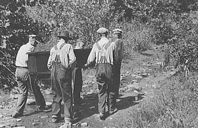 An image of men in South Appalachia carrying a coffin