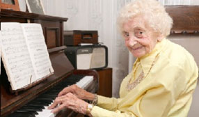 Elderly dementia patient plays the piano at The Restaurant of Mistaken Orders
