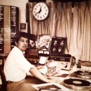 Black and white photo of Norman Fontaine working at CBC radio.