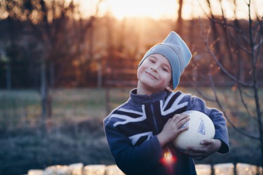 boy outdoors holding ball expressing quote to be yourself