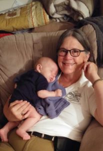 Ruth relaxing at home with an infant