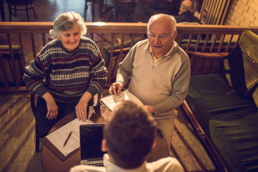 Elderly couple talking about pre-need plan with a funeral director