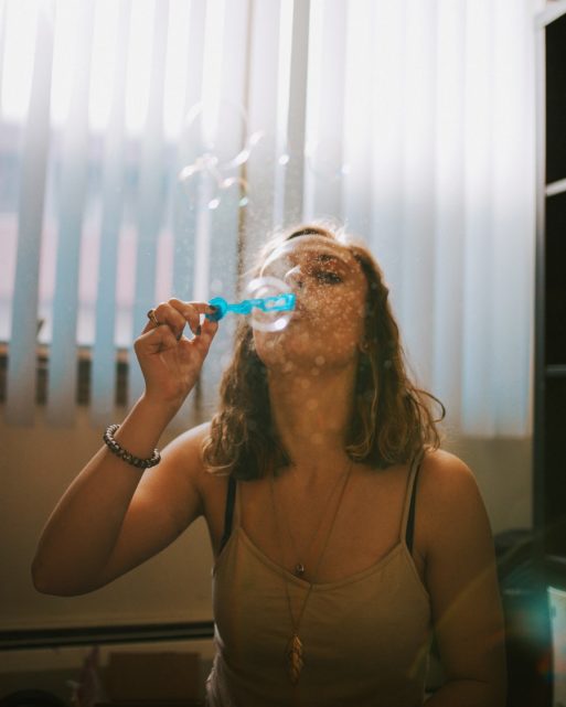 Woman blowing bubbles to live all the days of her life