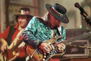 Stevie Ray Vaughan playing a guitar.