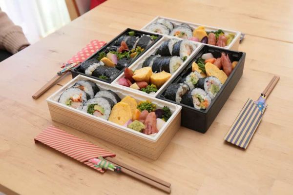 Numerous Japanese Bento boxes on a table.