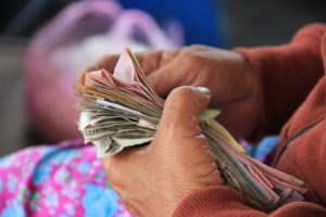 Woman with cash due to Long Term Care Savings for the elderly