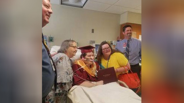 Dakota Johnson posing with loved ones in his cap and gown.