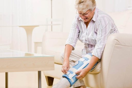 Senior woman puts on a brace obtained in Medicare scan