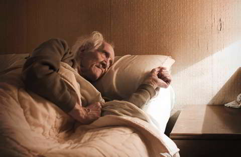 an elderly man in bed represents how loneliness is shortening LBGTQ lives