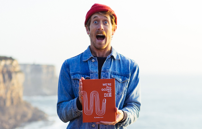 Stefan Hunt holding "We Are All Going to Die " Book
