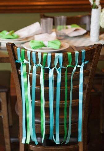image of a chair with ribbons on it as an example of how to decorate a place setting for a memorial service