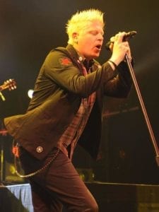 Dexter Holland of The Offspring singing "Gone Away" into a microphone.
