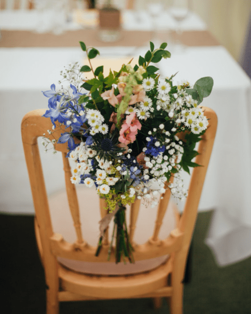 Image of a chair with flowers as an example of how to decorate a place setting for a memorial service