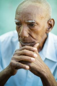 Elderly man staring ahead and thinking.