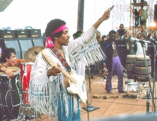 Jimi Hendrix salutes the crowd at Woodstock