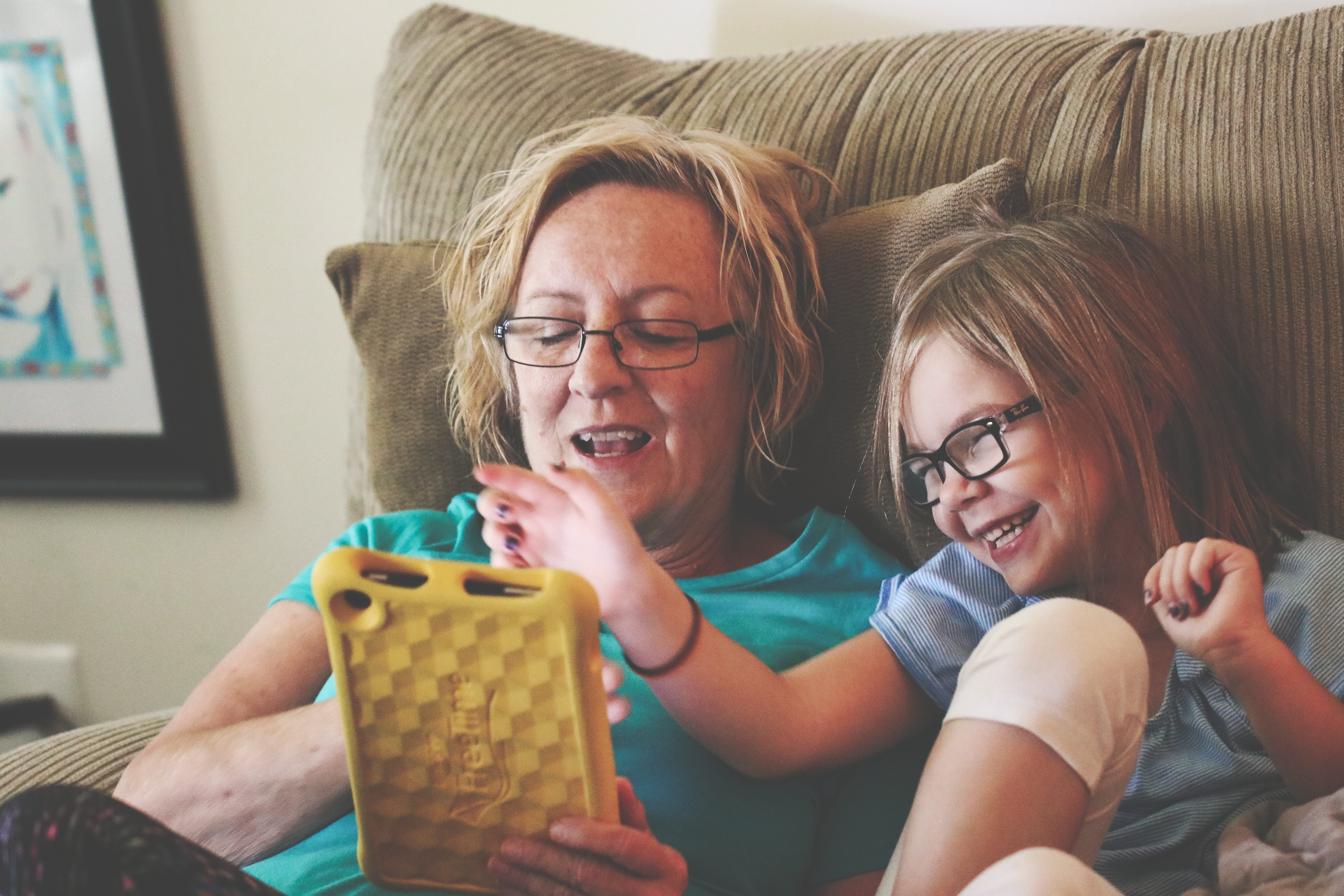 A woman and her daughter share a tablet when livestreaming a funeral.