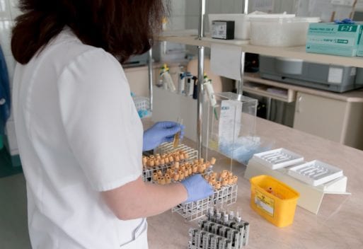 Medical professional performing an Alzheimer's blood test in a lab.