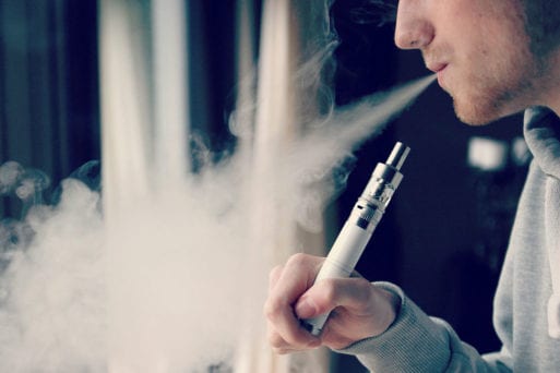 A person vaping which has been linked to three deaths