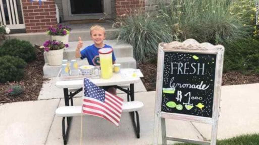 Brady Campbell sitting at his lemonade stand.