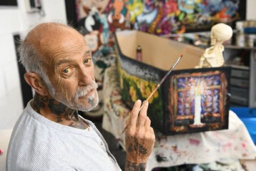 Tattoo artist Jeffery Beale painting his future coffin.