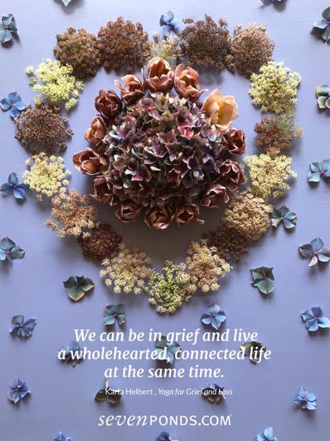A heart made of flowers with a quote about grief