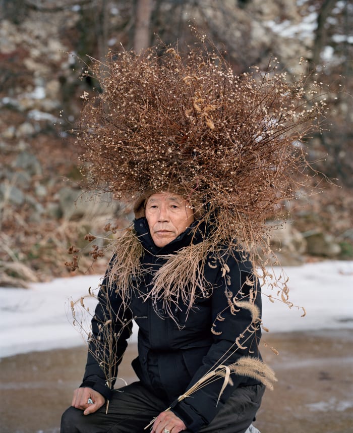 Mr. Ohi poses for "Eyes as Big as Plates" senior photograph project.