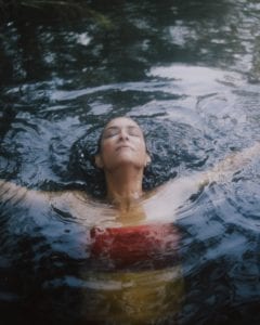 A woman submerged in water.