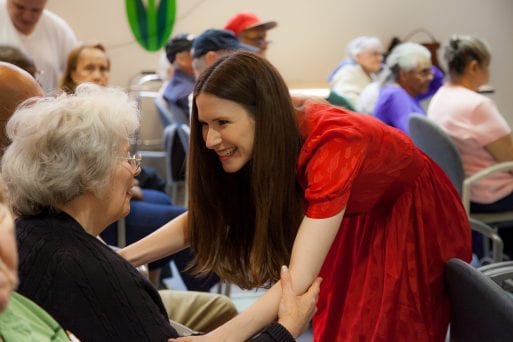 image of jackie vanderbeck and an elderly woman sing for your seniors