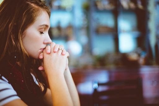 Image of sad woman at work with no bereavement leave as she experiences grief in the workplace