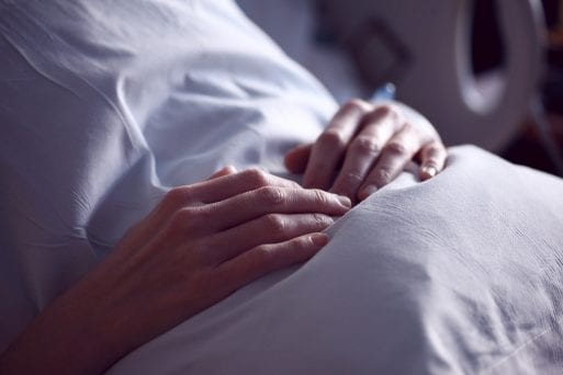 image of hands on pillow symbolizing someone receiving early palliative care