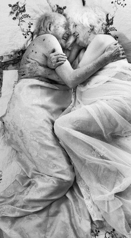 Paul (101) and Christine (87) display senior sexuality while embracing in bed.