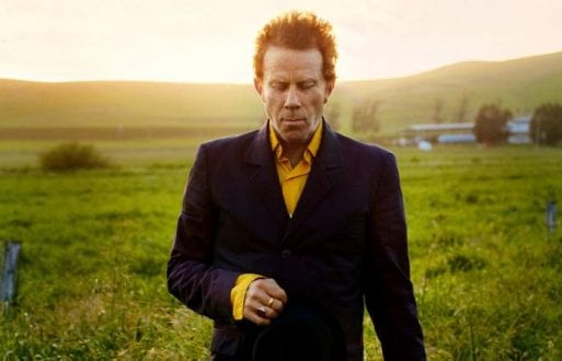 Image of Tom Waits in front of Green Grass 