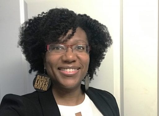 Selfie of Dr. Kami Fletcher wearing earrings that say “Black Lives Matter”