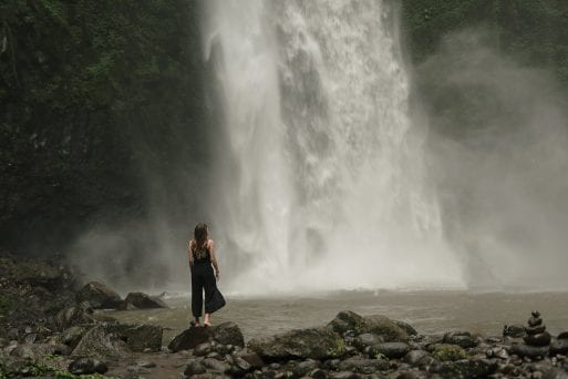 A woman regards a waterfall in a mourning ritual that also provides condolences.