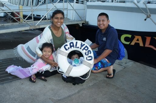 Belmi Tepeque poses with her family near a boat.