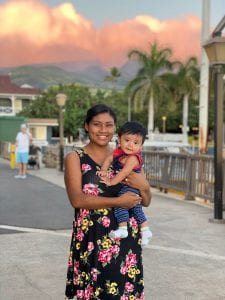 Belmi holds her son Isaiah in Hawaii.