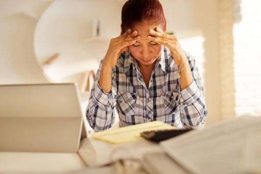 Image of senior women stressed because of COVID-19 scams and fraud