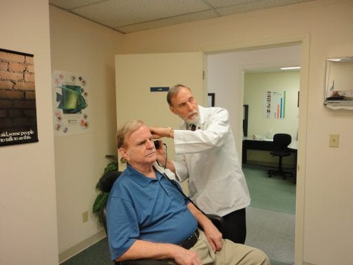 Image of man in doctor's office for age-related hearing impairment