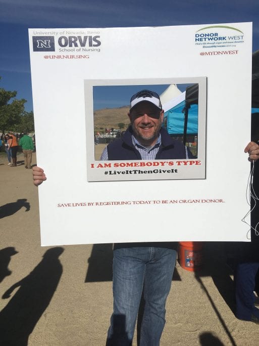John Lilley holds a sign to promote organ donation at the Great Reno Balloon Race.