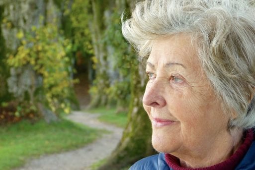 An elderly woman in outdoors, which could be more common in new senior living models.