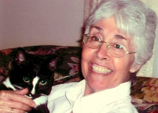 Kevin Jameson's wife Ginny with their black-and white cat, named Rudy.